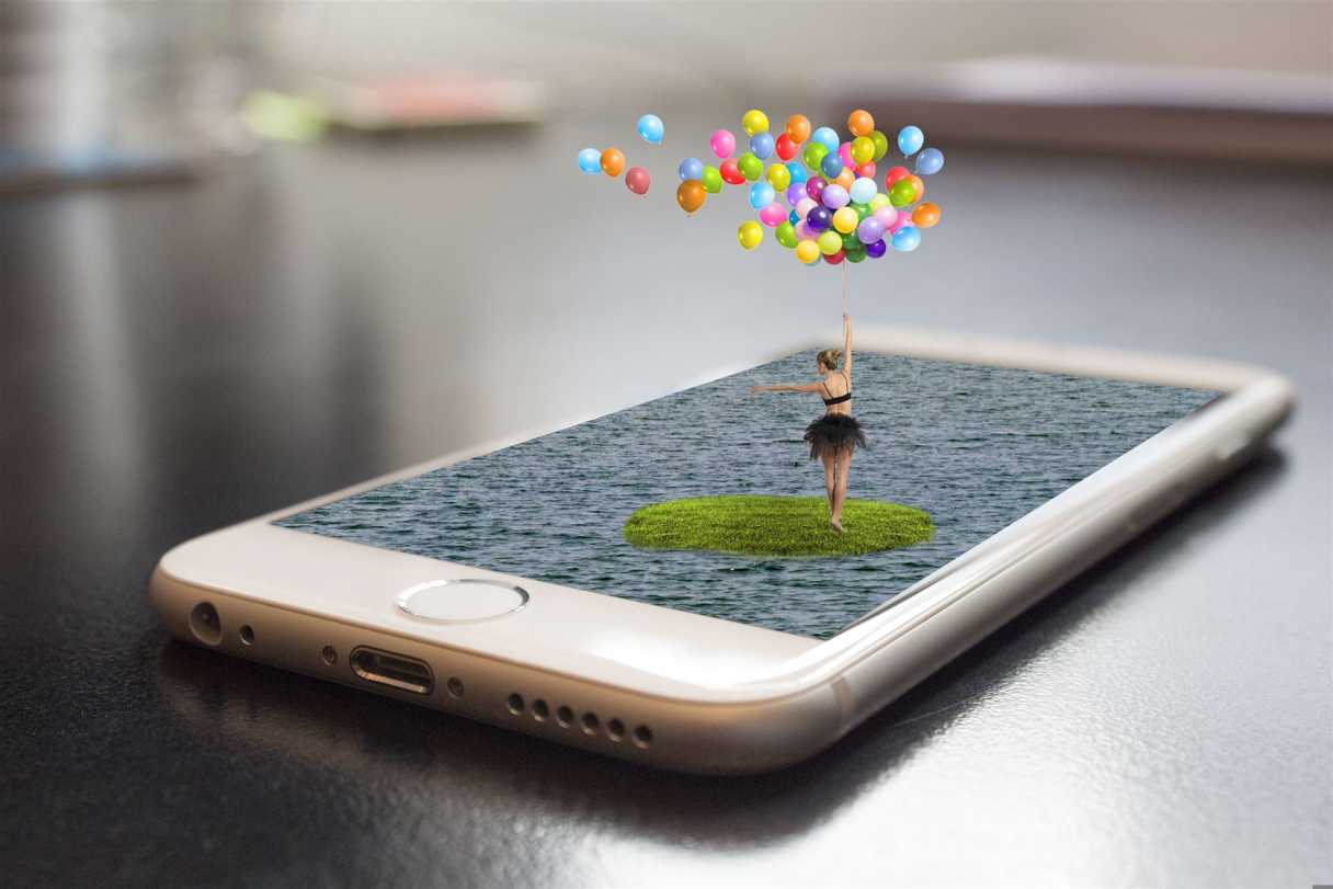 Symbolbilkd für unsere kreative Affinity Schulungen: Fotomontage eines Smartphone: eine Ballerina mit Ballons tanzt auf dem Display